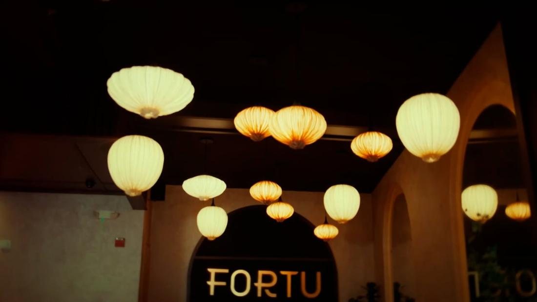 Amber paper lanterns above an arched entry