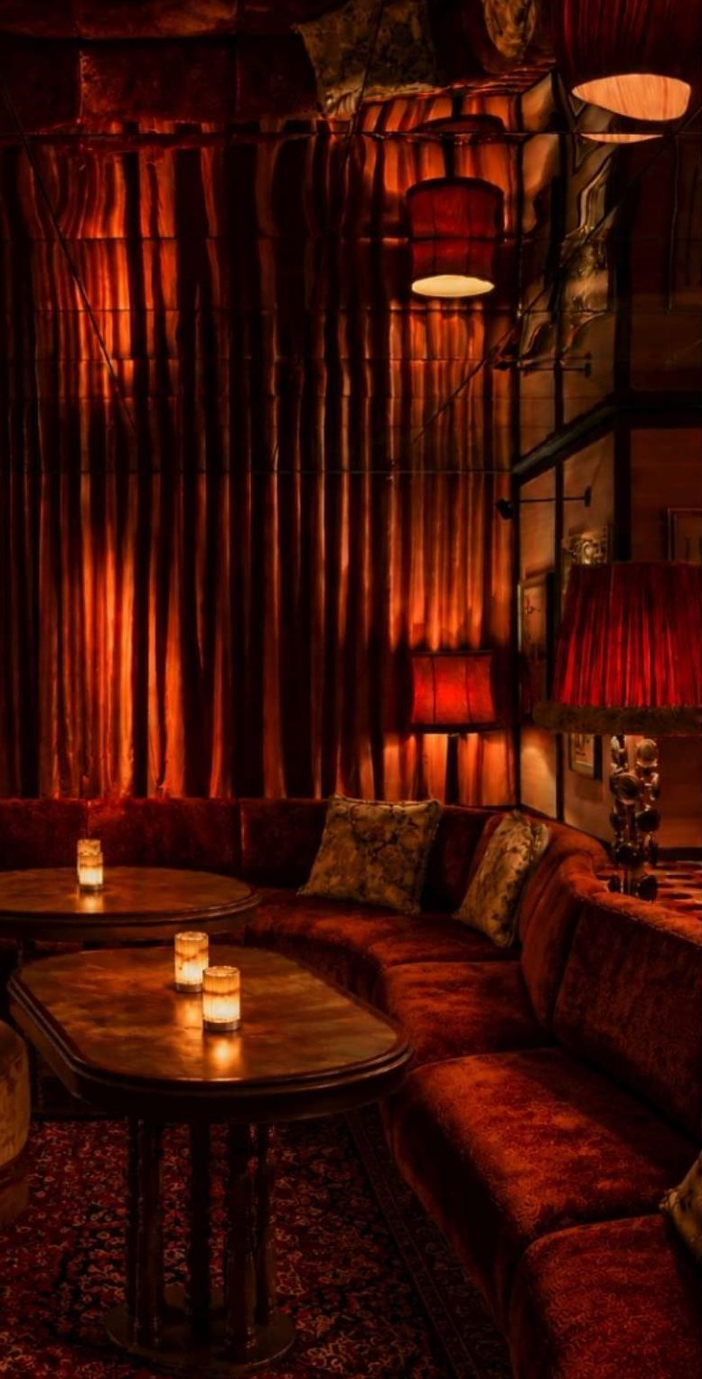 Velvet curtains and candlelit banquette seating