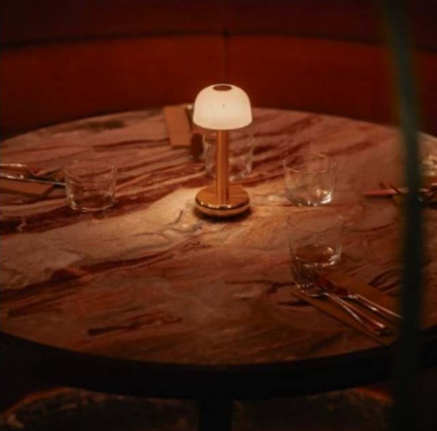 Marble table set with a portable brass lamp and glassware